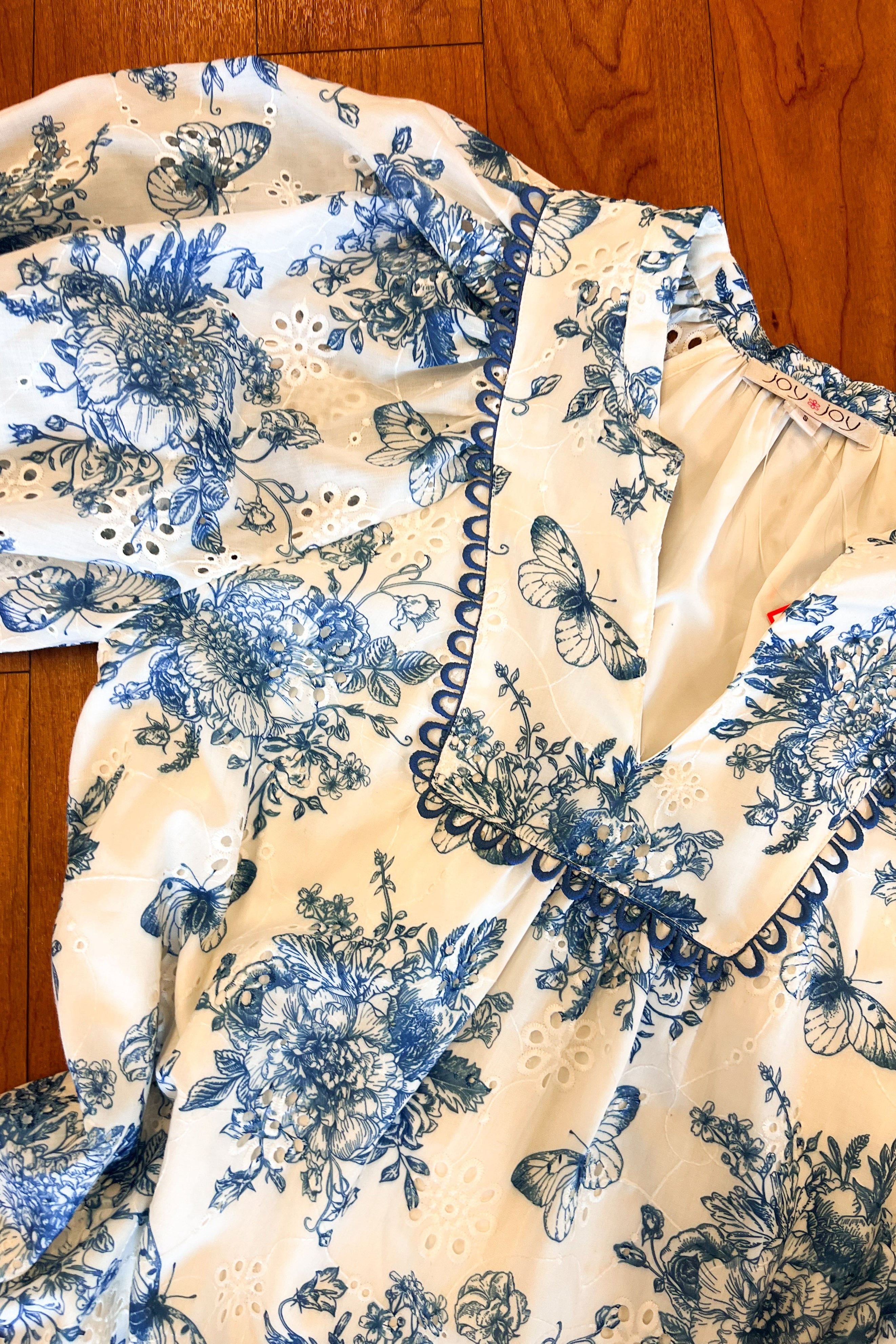 Floral and butterfly patterned fabric on a wooden surface