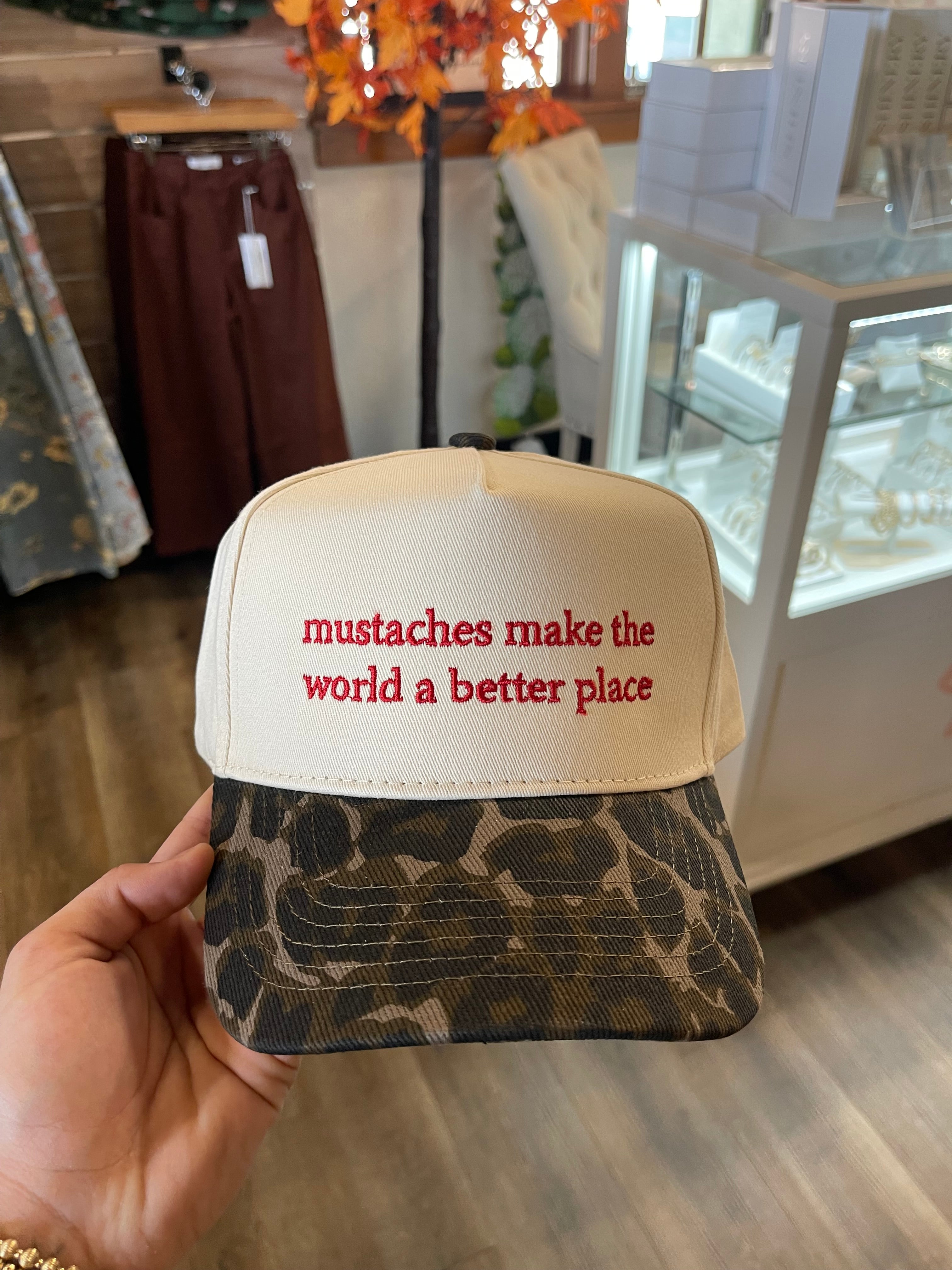 Mustaches make the world a better place trucker hat